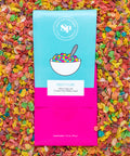 Fruity Flake chocolate bar with colorful cereal design, nestled in a bed of crushed, multicolored fruity pebbles.