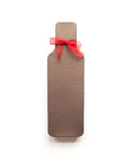 Wine bottle-shaped chocolate truffle box with red ribbon, ideal gift for wine lovers.