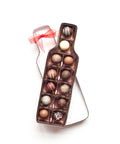 Wine bottle-shaped box with 12 handcrafted gourmet chocolate truffles, ideal gift for wine lovers, packaged with a red ribbon.