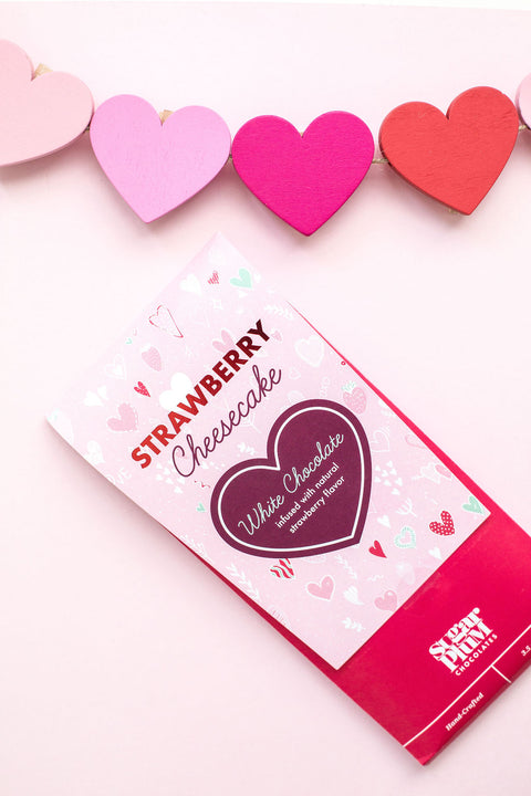 Strawberry Cheesecake White Chocolate Bar packaging with colorful heart decorations.