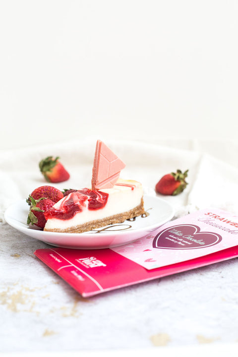 "Strawberry Cheesecake White Chocolate Bar with Fresh Strawberries on Plate"