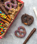 Chocolate Pretzel Passion Gift Box with assorted milk, dark, and white chocolate-covered pretzels topped with colorful candies.