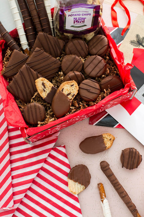 Gourmet chocolate gift box featuring chocolate-covered potato chips, cookies, and pretzels for a sweet and salty treat.