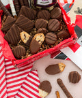 Gourmet chocolate gift box featuring chocolate-covered potato chips, cookies, and pretzels for a sweet and salty treat.