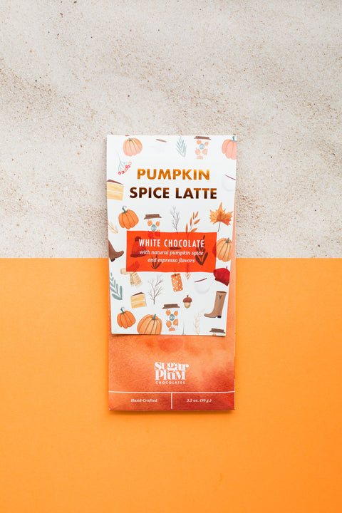 Pumpkin Spice Latte White Chocolate Bar on orange background with fall-themed packaging.