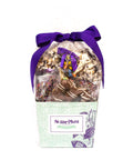 Gourmet chocolate gift basket by Sugar Plum with purple bow, featuring chocolate-covered snacks for holidays and special occasions.