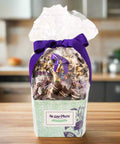 Gourmet chocolate gift basket by Sugar Plum, decorated with a purple ribbon, featuring handcrafted chocolate-covered treats.