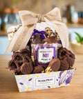 Chocolate Mountain Gift Basket by Sugar Plum with assorted handcrafted chocolates and snacks, wrapped with a bow.