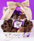 Chocolate Mountain Gift Basket with 17 handcrafted chocolates by Sugar Plum, featuring a festive bow on a vibrant backdrop.