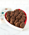 Heart-shaped box of milk chocolate-covered peanut butter cracker cookies, perfect sweet and salty treat with 20 handcrafted pieces.