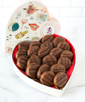 Heart-shaped box of milk chocolate-covered peanut butter cracker cookies, featuring 20 handcrafted sweet and salty treats.