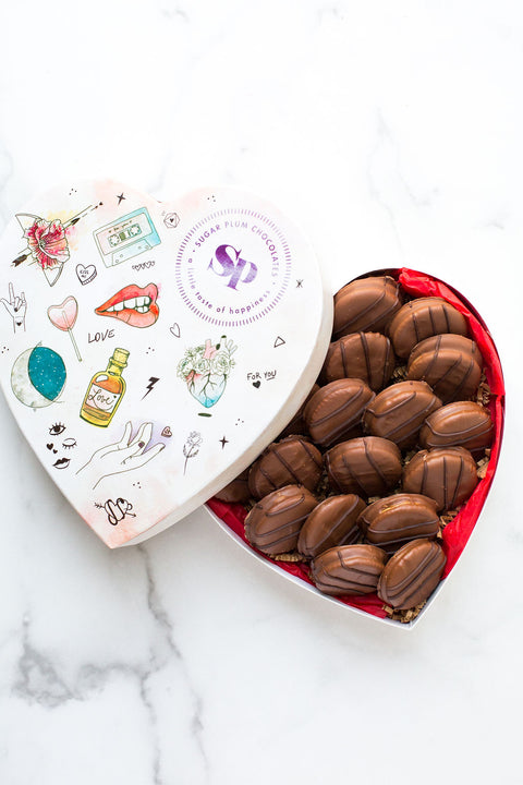 Heart-shaped box of milk chocolate-covered peanut butter cracker cookies, showcasing a delectable sweet and salty treat.
