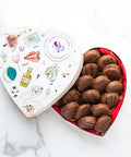 Heart-shaped box of milk chocolate-covered peanut butter cracker cookies, showcasing a delectable sweet and salty treat.