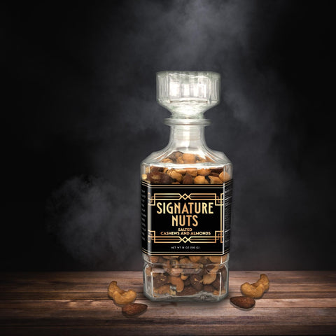 Premium salted cashews and almonds in elegant glass decanter, Damn Man Black Label, perfect gourmet gift for refined tastes.