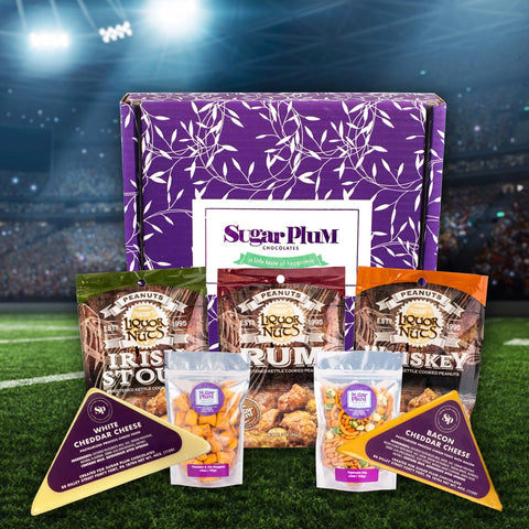 Game Day Snack Box with cheese, pretzel nuggets, and gourmet nuts against a sports stadium backdrop.