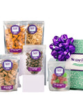 Gift box of assorted snacks with purple bow and labeled pouches, including nuts, chocolates, and gummies from Sugar Plum.