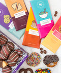 Nostalgic Chocolate Bar Gift Box with assorted flavors and sweet treats, featuring colorful packaging and chocolate-coated pretzels.