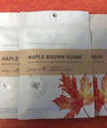 Five-pack of Maple Brown Sugar Vegetable Seasoning on an orange background, featuring maple leaf design packaging.