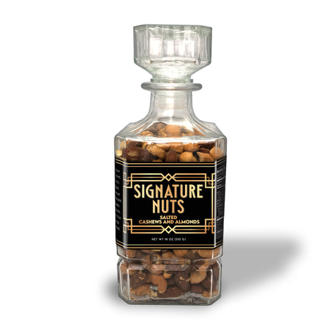Premium salted cashews and almonds in elegant glass decanter for refined tastes, Damn Man Black Label.