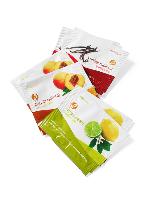 Assorted gourmet tea packets including peach oolong, vanilla rooibos, and citrus green, part of a comforting snack care package.
