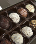 Wine truffle box with 12 handcrafted gourmet chocolate truffles in assorted flavors, perfect gift for wine lovers.