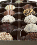 Gourmet chocolate truffles in a wine bottle-shaped box, perfect gift for wine lovers, featuring 12 assorted handcrafted flavors.