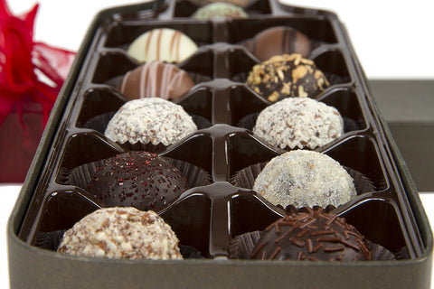 Gourmet chocolate truffles in a wine bottle-shaped box, perfect gift for wine lovers, featuring 12 assorted handcrafted flavors.