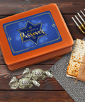 Kosher for Passover Pareve Dairy-Free Truffles with festive gift tin, matzah, and menorah on a wooden table.