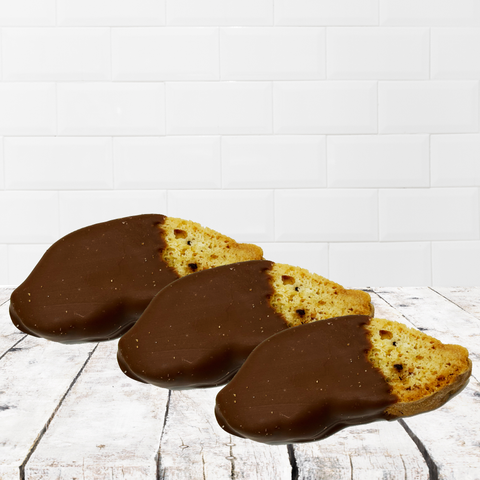 Three chocolate-dipped biscotti on a rustic wooden table, part of a thoughtful get-well-soon gift box for comfort and recovery.