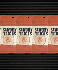 Five-pack of Savory Texas BBQ Seasoning featuring bold BBQ spice blend packaging on a textured background.