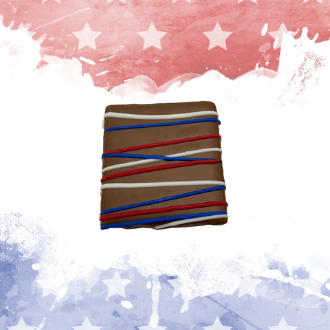 Patriotic chocolate square with red, white, and blue drizzle on an American flag-themed background.