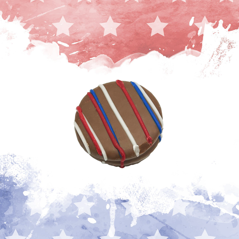 Patriotic chocolate with red, white, and blue drizzle on American flag background, perfect for celebrating Independence Day or Veterans Day.