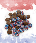 Patriotic chocolate candies with red, white, and blue sprinkles on a festive background for Independence Day and Veterans Day celebrations.
