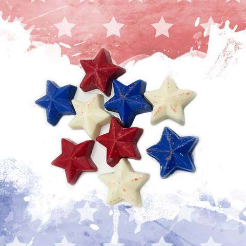 Patriotic chocolate stars in red, white, and blue on festive American flag backdrop for holiday celebrations.