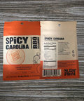 Spicy Carolina BBQ Seasoning packaging on a wooden table, showcasing nutritional information and branding by Sugar Plum.