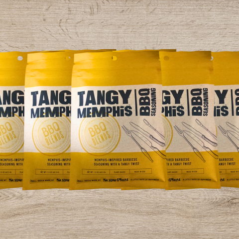 Five packs of Tangy Memphis BBQ Seasoning on a wooden surface, perfect for pork ribs, pulled pork, and brisket.