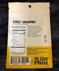 Back of Tangy Memphis BBQ Seasoning pack showing ingredients and nutrition facts on wooden background.