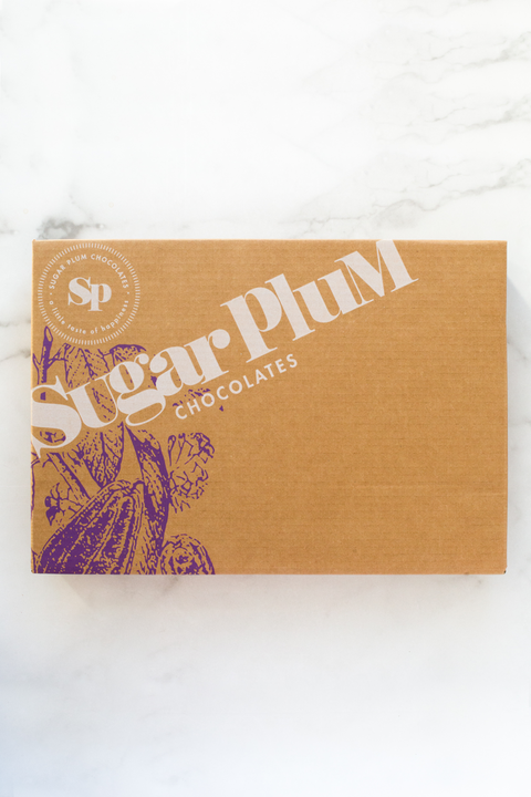 Sugar Plum Double Decadence Dark Chocolate Gift Box on marble background, perfect for special occasions and gifting.