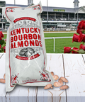 Kentucky Bourbon Almonds package in front of the Derby racetrack with red roses, showcasing Southern flavor delights.