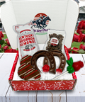 "Kentucky Derby Chocolate & Nuts Box featuring bourbon almonds, butter pecans, chocolate horseshoes, and rose lollipops."
