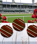 Chocolate-covered treats with red and white drizzle in front of the Kentucky Derby racetrack and vibrant red roses.