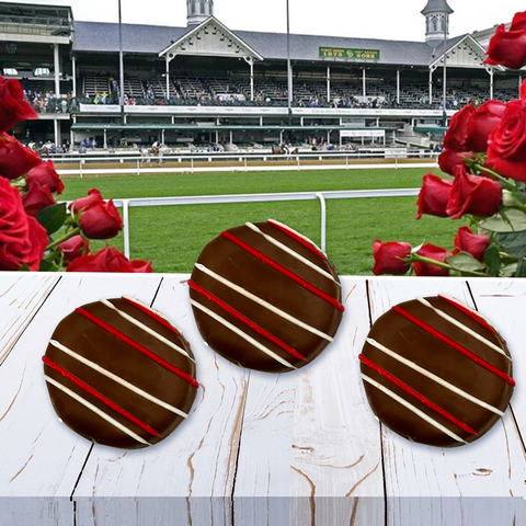Chocolate-covered treats with red and white drizzle in front of the Kentucky Derby racetrack and vibrant red roses.