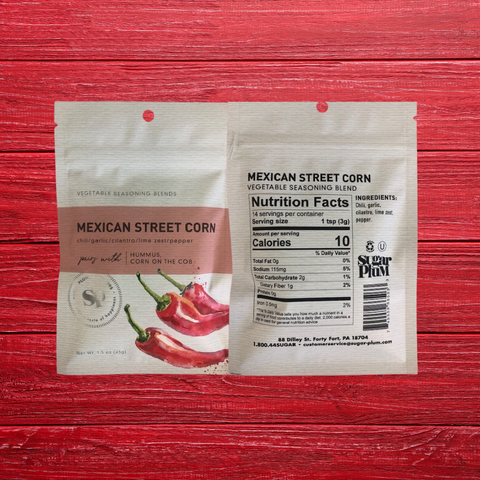 Mexican Street Corn Vegetable Seasoning 5-pack with chili, lime, garlic spice blend on red wood background.