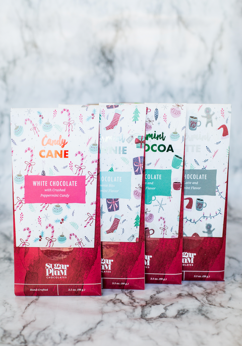 Sugar Plum Peppermint Chocolate Bar Holiday Collection 4-pack with festive flavors on a marble background.