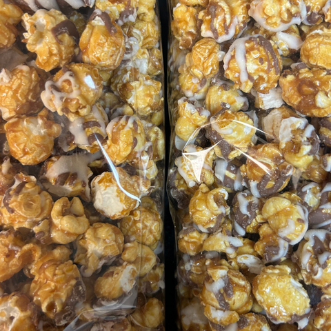 Gourmet caramel corn with white and milk chocolate drizzle in a gift box, handcrafted snack by Sugar Plum.