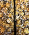 Gourmet caramel corn with white and milk chocolate drizzle in a gift box, handcrafted snack by Sugar Plum.